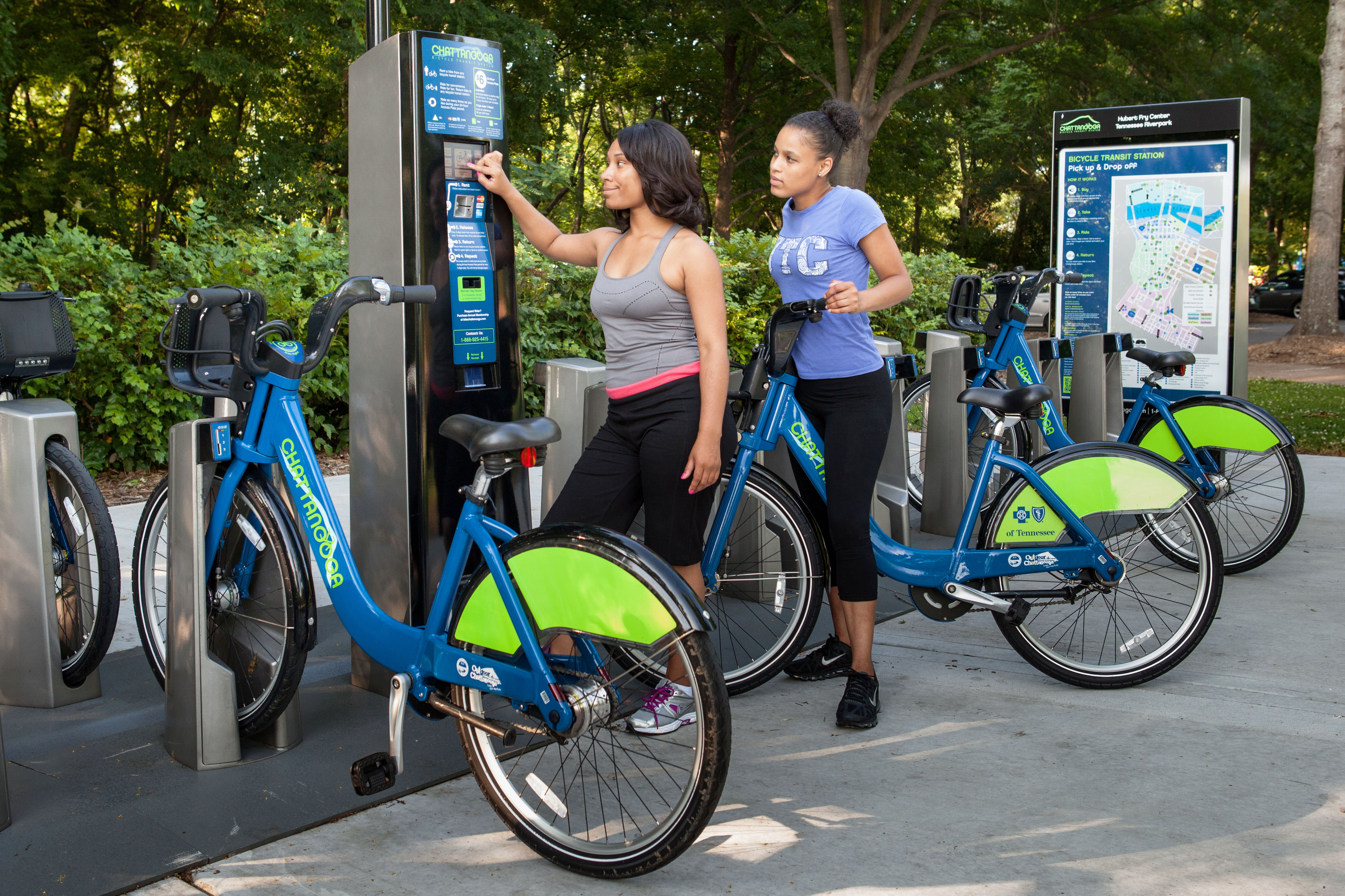 Two women by a rent a bike station
